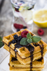 Belgian waffles with raspberries, blueberries and mint, covered