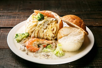 pasta with cream sauce in bread