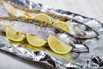 Raw mackerel in foil close up. Preparation of fresh fish.
