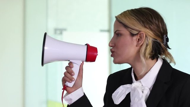 Buisness woman shout with loudspeaker side view