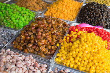 Colorful dried salted or sugared Asian tropical fruits