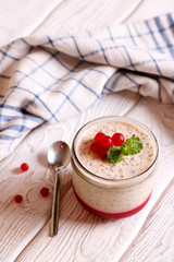 Homemade chia pudding with berry fruit in the jar, vertical