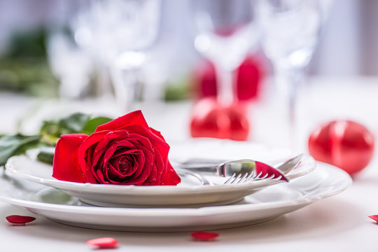 Table Setting For Valentines Or Wedding Day With Red Roses. Romantic Table Setting For Two With Roses Plates Cups And Cutlery.