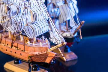 toy model boat on the blue and black background.