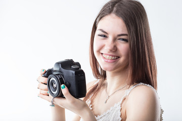 young woman in braces and a reflex camera