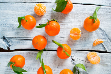 tangerines with green leaves on turquoise wooden background