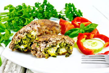 Cutlets stuffed in plate on board