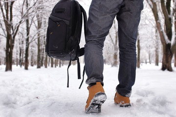 bearded man walking in a winter park