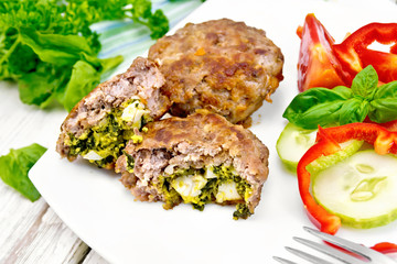 Cutlets stuffed in plate on light board