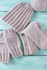 knitted clothes on turquoise wooden background