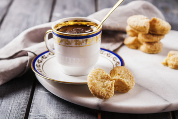 Cup of tea and cookies on a marble tray. Breakfast. Morning. Selective focus 
