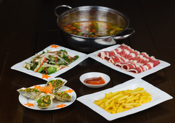 Set of Asian food with Fried Crispy Potato, Barbecue geoduck with onion and grease, Shrimp stir-fried vermicelli, hot pot with raw beef slide