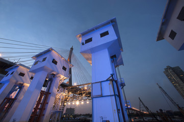 Fototapeta premium Floodgate with Bhumibol bridge in Thailand at night.
