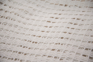 White shirt tied in hand photographed in close-up.