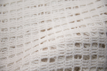 White shirt tied in hand photographed in close-up.