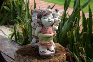 stone figurines on a tree stump
