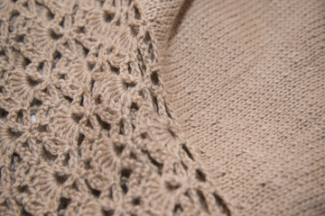 Brown sweater knitted in manual photographed in close-up.