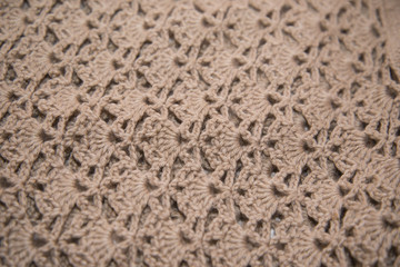 Brown sweater knitted in manual photographed in close-up.