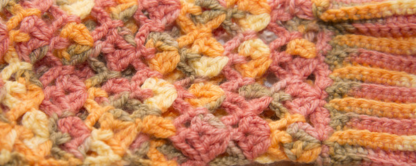 Color sweater knitted in manual photographed in close-up.