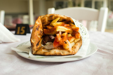Greek Kebab - Meat with vegetables in pita bread roll.