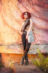 girl with bright makeup at the ruins of an old house