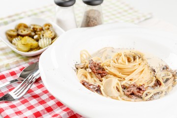 steak cream pasta on table