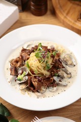 steak cream pasta on table