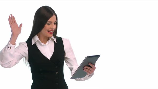 Using skype. Young pretty woman holding tablet computer