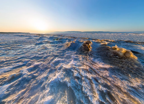 Aerial panorama of snow sunrise wave on the shore of Olkhon. Bai