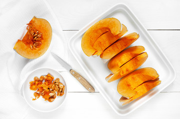 Slices pumpkin on the white wooden table