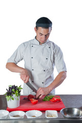 chef in the kitchen preparing a meal knife cuts vegetables on th