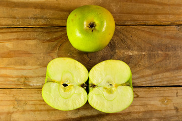 Green apple on a wooden table