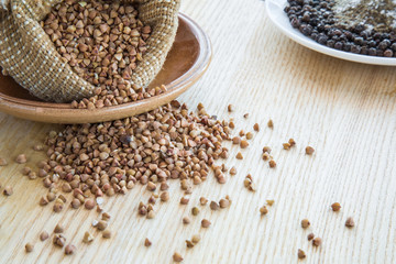 Buckwheat on the wooden board. Healthy eating and lifestyle.