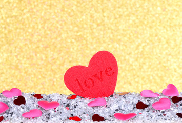 The red heart shapes on abstract light gold glitter background in love concept for valentines day and romantic moment