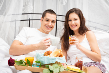 Couple Having Breakfast In Bed