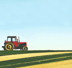 Fototapeta premium Tractor in a field