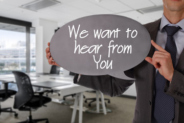 We want to hear from you. Businessman holding blackboard. Business vision, success, team work, leadership concept