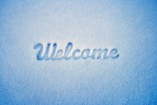 Welcome message imprint in the snow. Winter landscape.