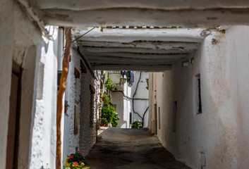 Beautiful view of a narrow street in a village of La Alpujarra,