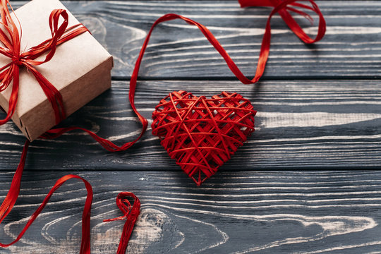 valentine concept. stylish red present and heart ribbons on blac