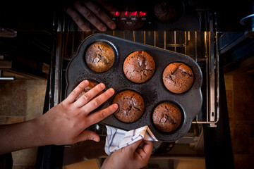 Cake chocolate fondant cake in home oven on the dark black background. Good for menu recipt book...
