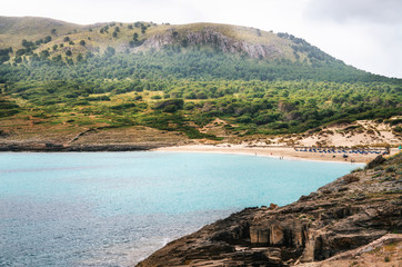 Cute bay of Majorca island. View of Cala Mesquida with sand beach and azure turquoise sea from cape of Sa Cantera, Mallorca, Baleares, Spain
