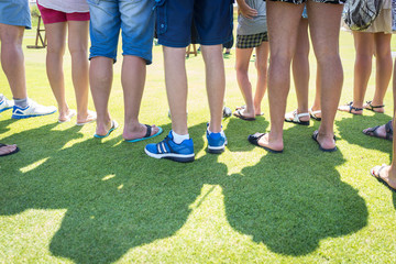 People feet on green grass