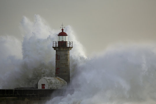 Stormy wave over lighthouse