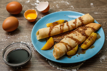 Wooden table with two pancakes