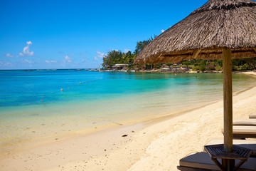 White sand beach with lounge chairs and umbrellas in Mauritius I