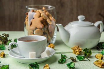 White teapot and cup with tea