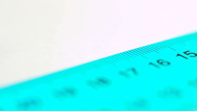 Using ruler on white paper.