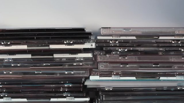 Empty and used DVD/CD boxes in the drawer. Background type of use.