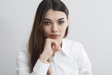 Portrait of young woman on gray background